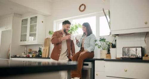 Young Couple Enjoying Coffee in Modern Kitchen