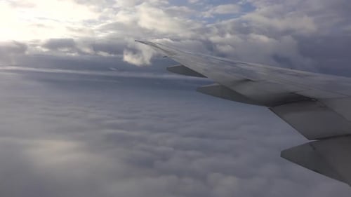 Looking out a plane window at clouds