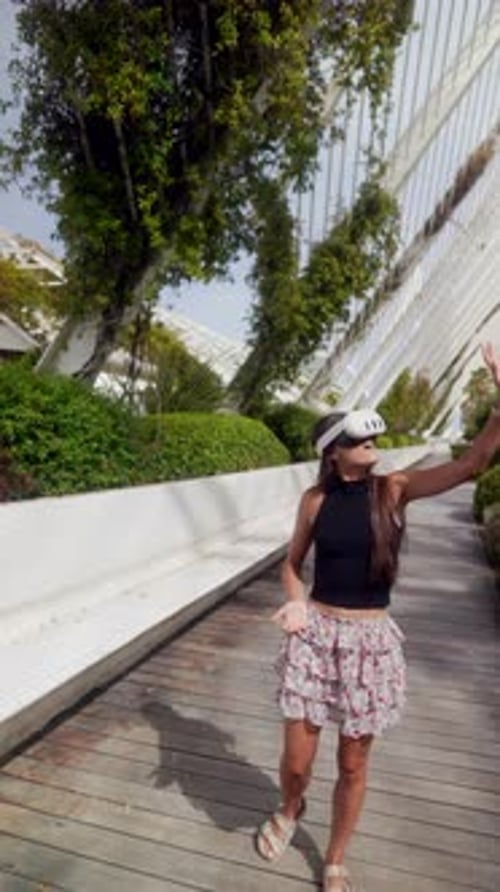 Woman Uses VR Headset in Landscaped Park