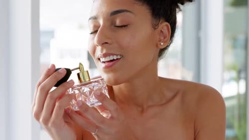 Woman Spraying Perfume in Bathroom