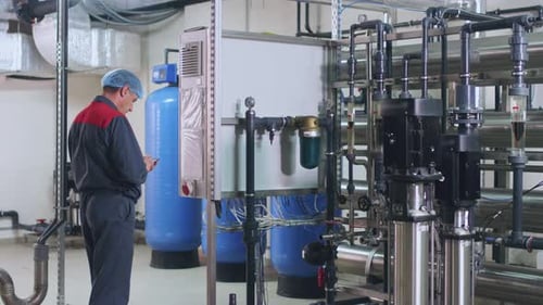 Factory Worker Control Engineering Equipment. Man Engineer Check Water Purification System. Industry