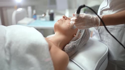 Caucasian Female Getting RF Face Lifting Procedure