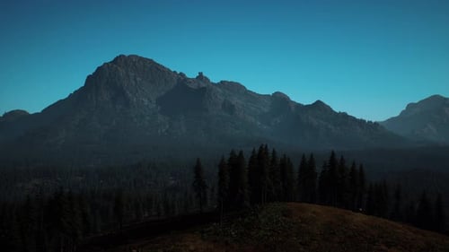 A View of a Mountain Range with Trees in the Foreground