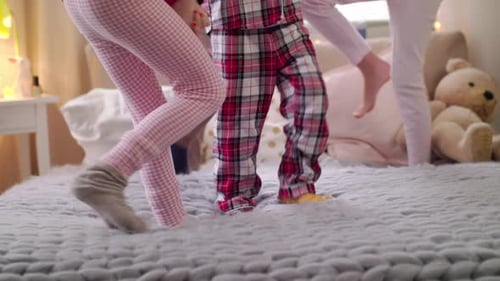 Girls Playing on a Bed in Pajamas