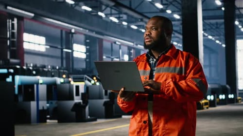Industrial Staff Member Oversees Assembly Work in a Warehouse