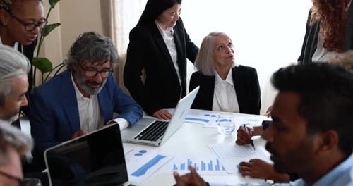 Multiracial business team collaborating on startup strategy in modern bank office
