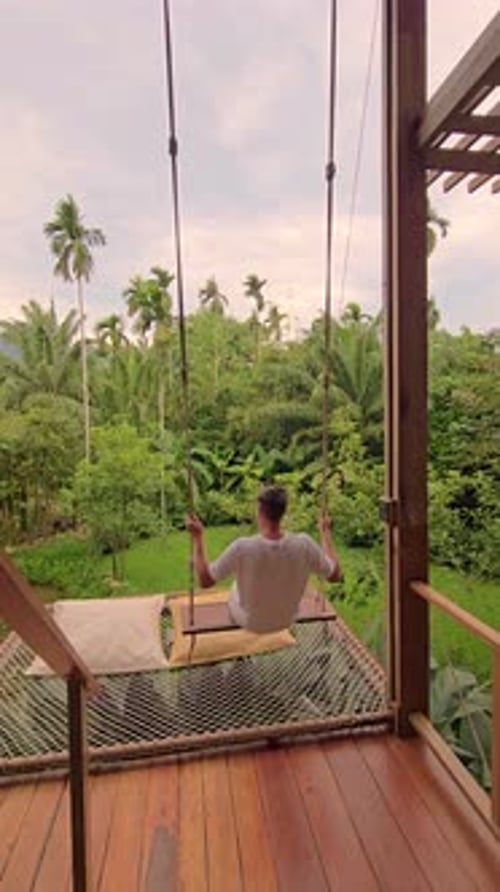 Relaxing on a Garden Swing Surrounded By Lush Greenery in a Tropical Paradise