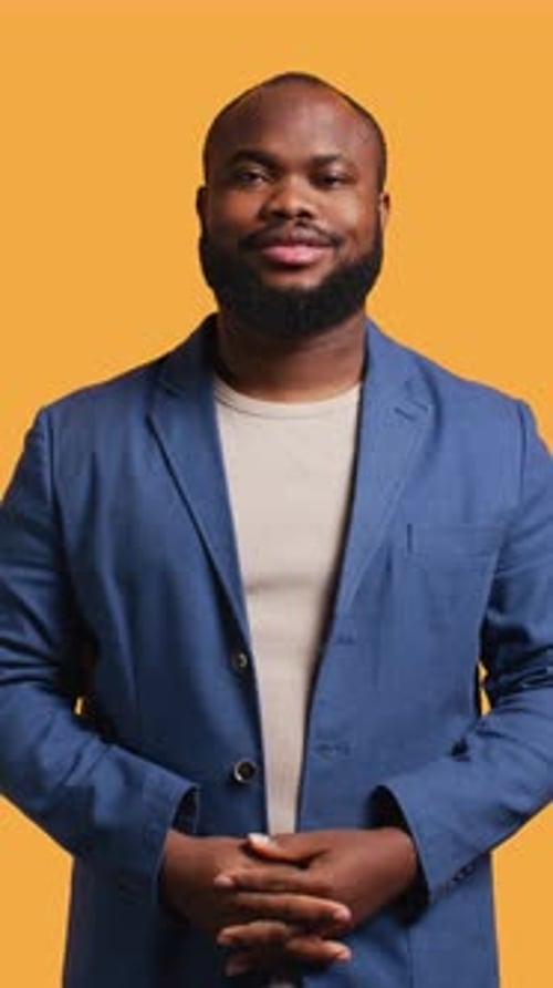 Vertical Video Portrait of Cheerful Man Smiling Looking Pleased Studio Background