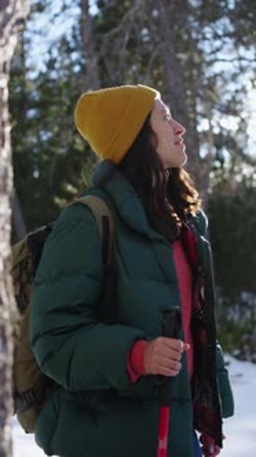 Latina Woman Standing in a Snowy Landscape Looking Around with Wonder Surrounded By Serene
