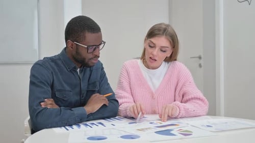 Business Colleagues Reviewing Charts and Graphs Together