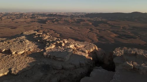 Aerial dolly across the edge of the Makhtesh Ramon Crater In Negev Desert, Israel.