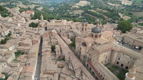 Aerial view of Urbino Centro Storico showcasing its historic buildings, winding streets, and the sur