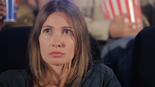 Woman Watches Thriller at the Movie Theater
