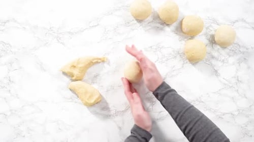 Hands Preparing Dough on Marble Countertop