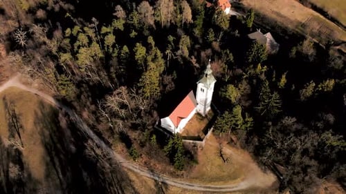 Aerial flight over a church in Slovenia with the camera looking directly down on the Churchs itself.