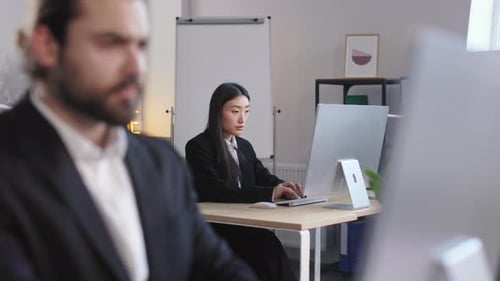 Male and Female Colleagues Working in Open Space Office