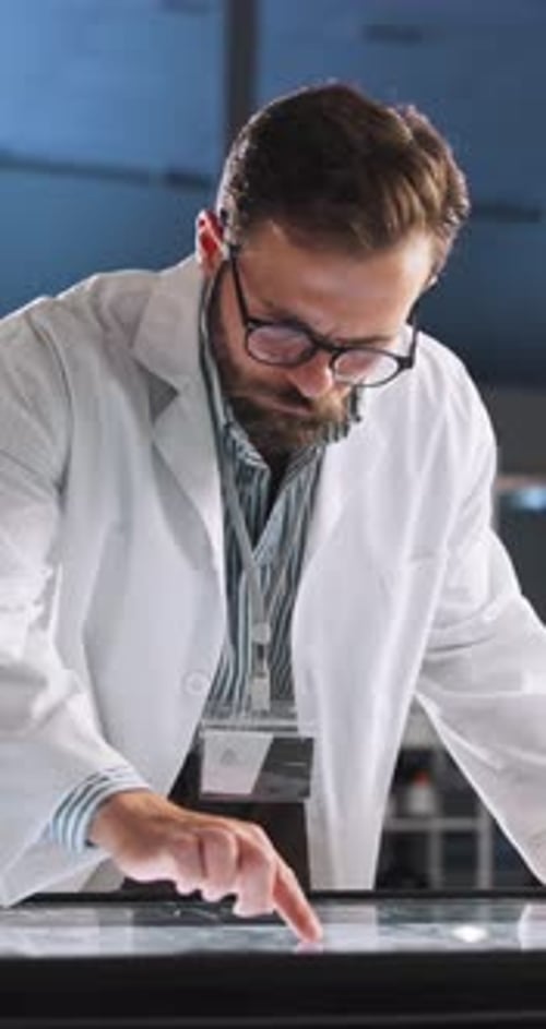 Scientist Interacting with Futuristic Touchscreen Display in Lab
