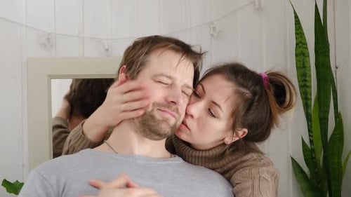 Affectionate Couple Embracing and Kissing Tenderly at Home