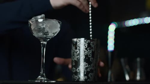 Close Up of a Bartender is Mixing an Alcoholic Cocktail at the Bar or Disco Club Media Process of
