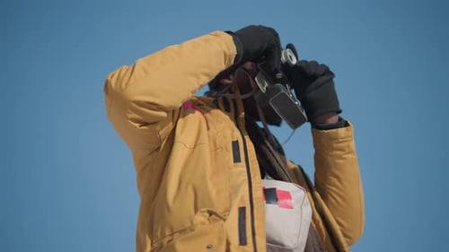 Person with Vintage Camera Posing Outdoors on Sunny Day
