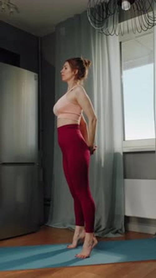 Woman Stretching and Warming Up Body at Home