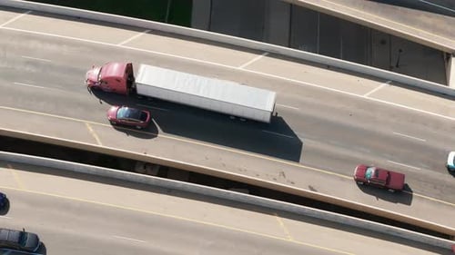 Aerial Top Down View of Traffic Intersection with Overpasses Highways with Moving Cars and Red