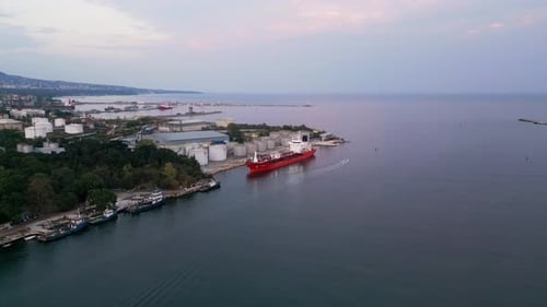 Tanker Ship Refueling at an Oil Terminal with Storage Silo's in the Port Aerial View