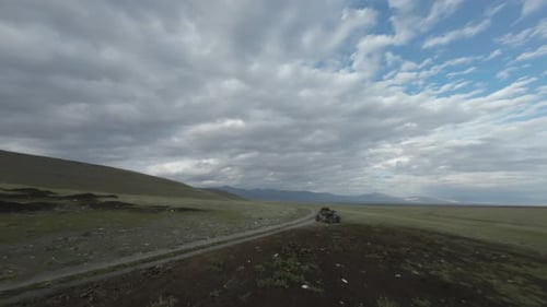 Buggy trip in a Altai desert. Mountain landscape with hills and beautiful blue sky with clouds.