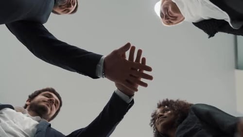 Close Up of Happy Multiethnic Adult Business People Holding Hands Together