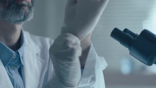 Scientist Putting on Gloves in the Lab