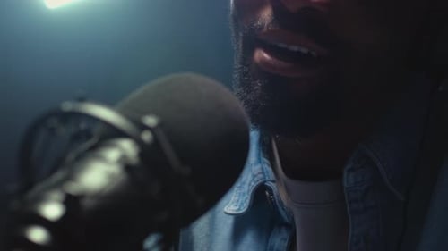 Man Talking Into Microphone in Recording Studio Close Up