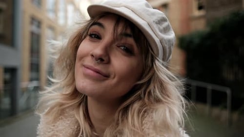 Close-up of beautiful model looking at camera in the street.