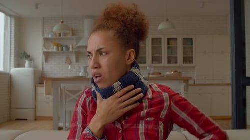 Sick Lovely African American Woman with Sore Throat Coughing at Home