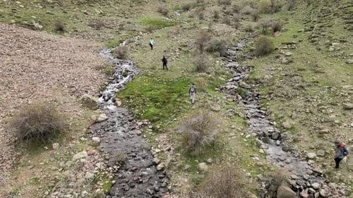 Aerial View of Hikers by Mountain Stream