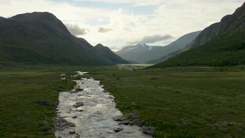 Get a Bird's Eye View of Nature's Beauty: Aerial Footage of Flying Over a Mountain River 4K
