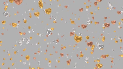 Shiny Gold Silver And Bronze Heart Ornaments Falling In Slow Motion