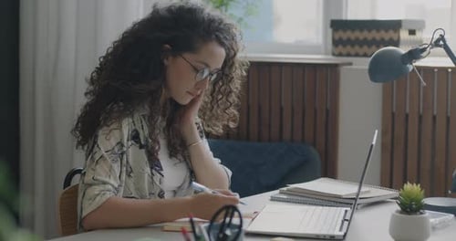 Woman Working on Laptop at Home Office Desk
