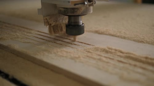 Closeup of a Powerful Wood Carver Working with Plywood in a Carpentry Workshop