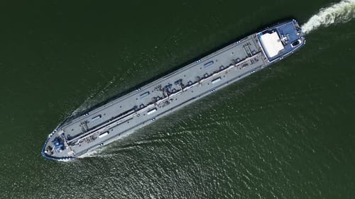 Oil Tanker Ship Navigating Along Waterway, Aerial Top Down View