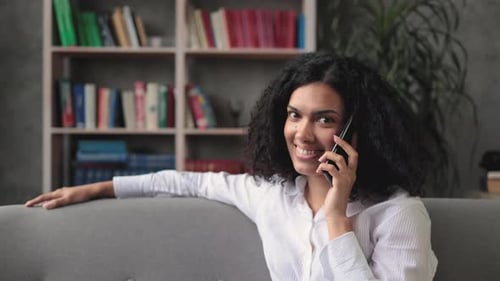 Woman Smiling Talking on Mobile Phone at Home