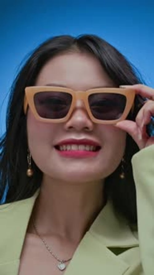 Stylish Woman in Sunglasses Smiling in Portrait