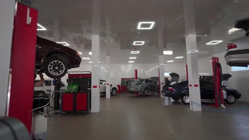 Car Repair Shop with Mechanics Servicing Vehicles