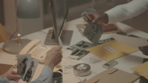 Detectives Discussing Photos from Crime Scene in Office