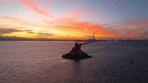 Poolbeg Lighthouse at Sunset in Dublin Bay Ireland