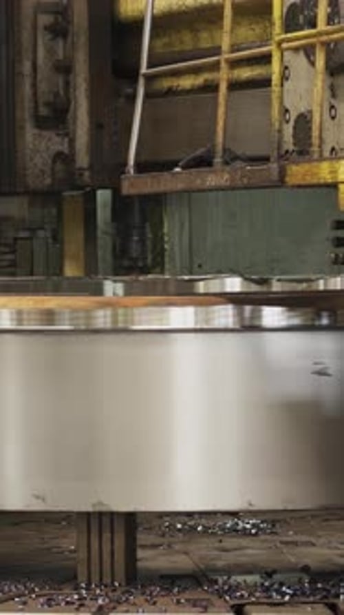 Industrial Machine Cutting and Shaping Metal in Factory