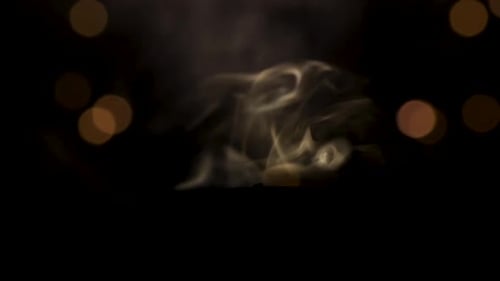 Candle Burning then Extinguished in Darkness with Bokeh