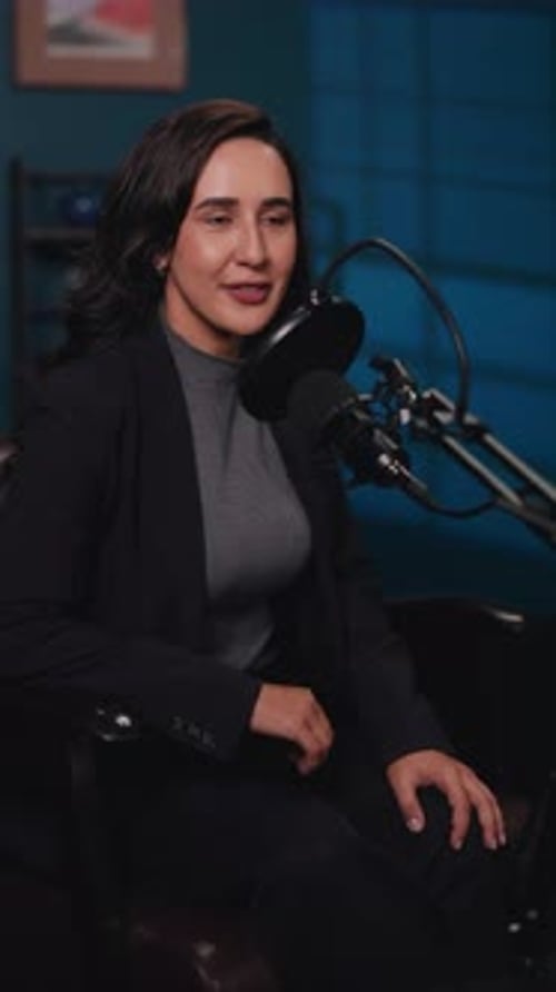 Portrait of Brunette Woman Conducts Podcast Show in Recording Studio