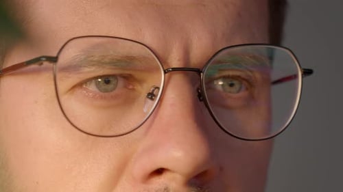 Close Up of Man Wearing Glasses Working at Computer