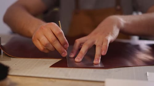 Tailor Cuts Part of Leather with Cast in Craft Studio