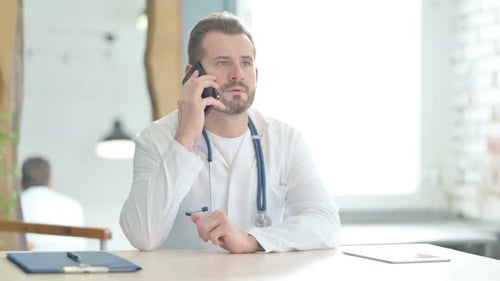Doctor Talking on Phone in Clinic